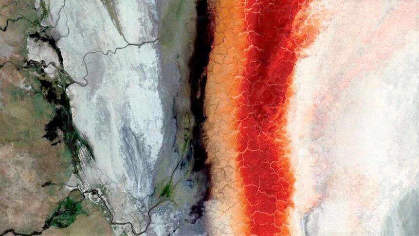 Aerial image of empty lake with red and orange saline buildups
