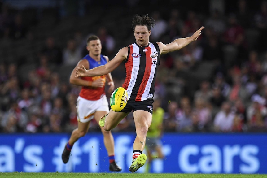 St Kilda's Jack Steven (R) in action against Brisbane at Docklands on March 24, 2018.