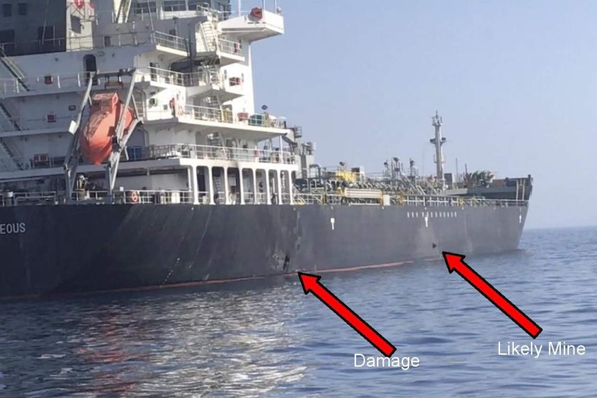 A US Central Command photo shows alleged damage and an unexploded limpet mine on the ship's hull.