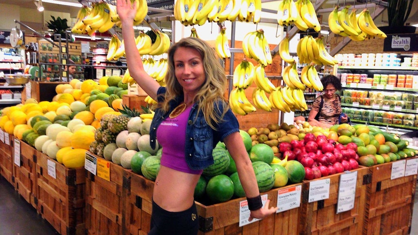 Photo of woman standing in a fruit shop