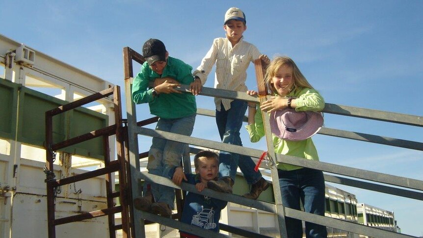 The four White children on a portable loading ramp at Mitchell Wells