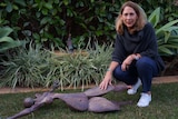 Carolyn Stewart in her garden with the returned sculpture.