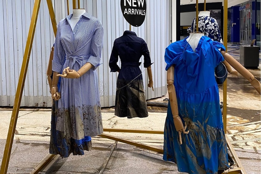 Dress mannequins with mud from floodwaters