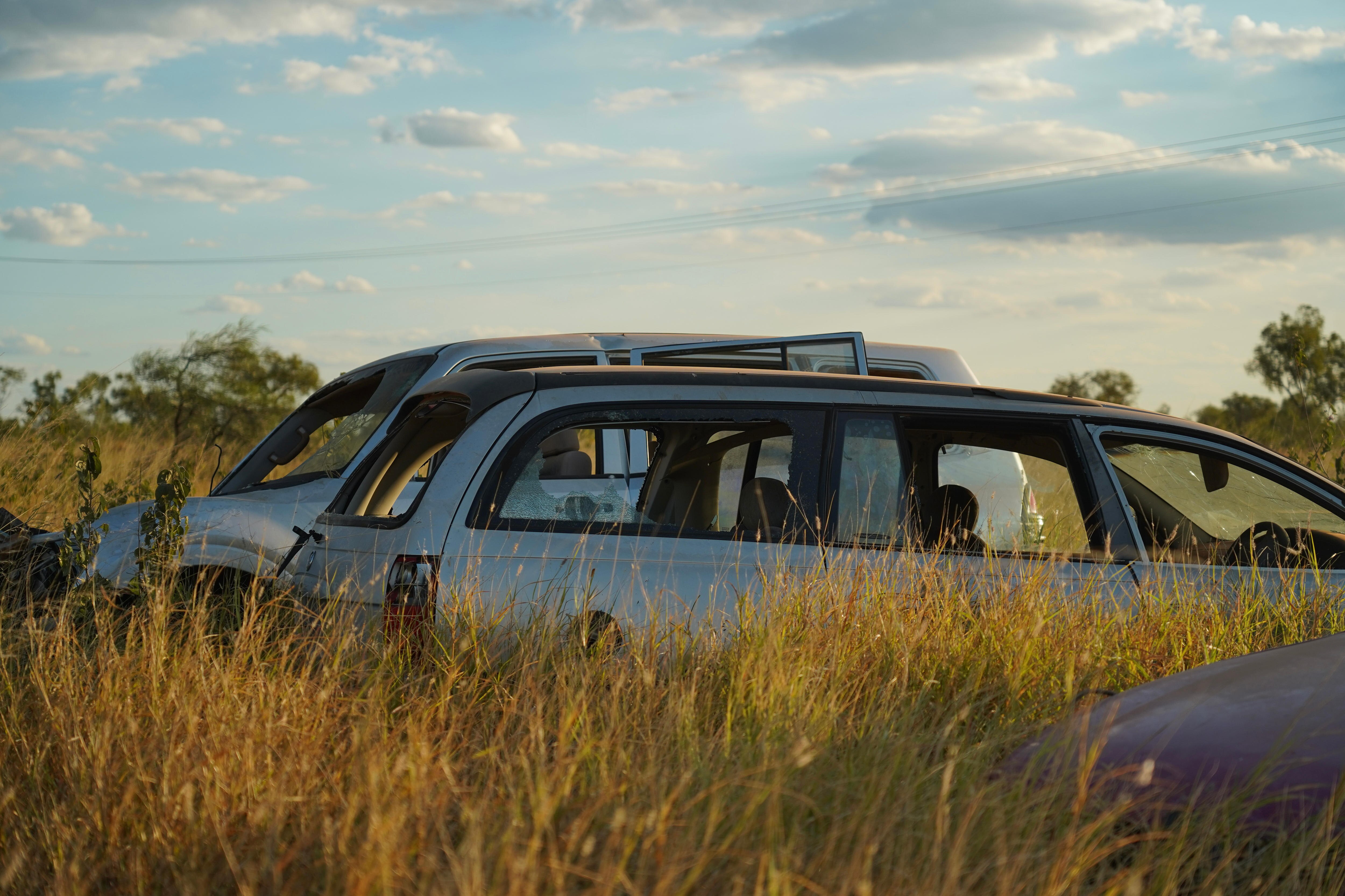 Busted car in long grass