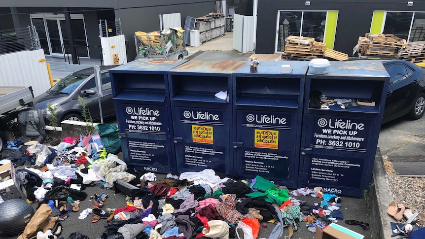 Donation bins at Lifeline at Newmarket overflow with old clothes.