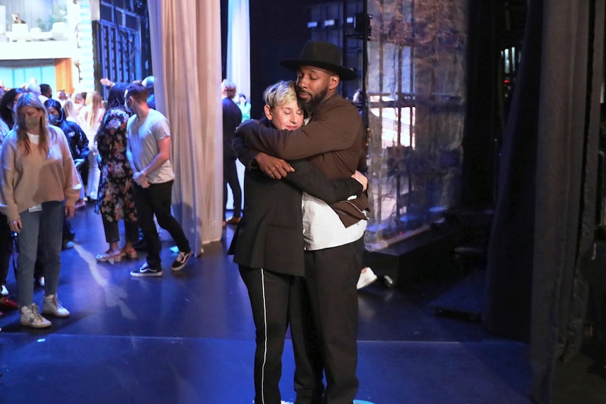 Ellen embraces Stephen "tWitch" Boss on stage.