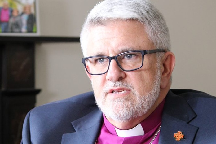 Medium shot of Anglican Bishop of Tasmania, Richard Condie talking