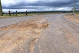 Large sandy potholes on a country road