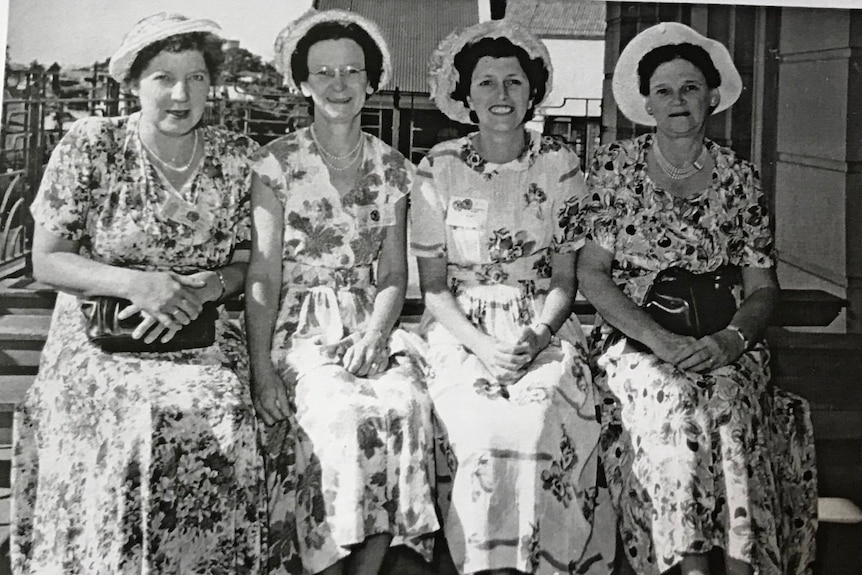 A black and white picture of a group of women