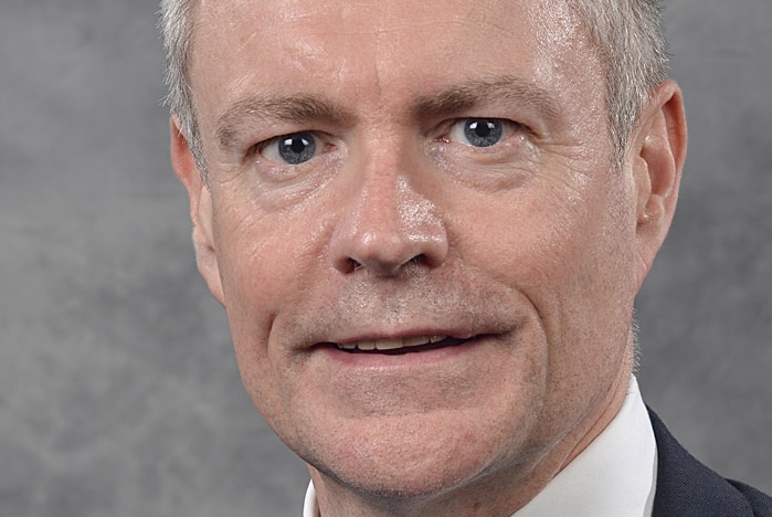 Corporate head and shoulders image of man in suit and tie.