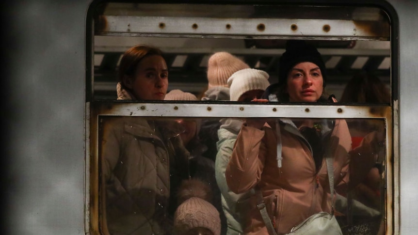 Passengers look out of a train win arriving in Poland on a train from Odessa in Ukraine.
