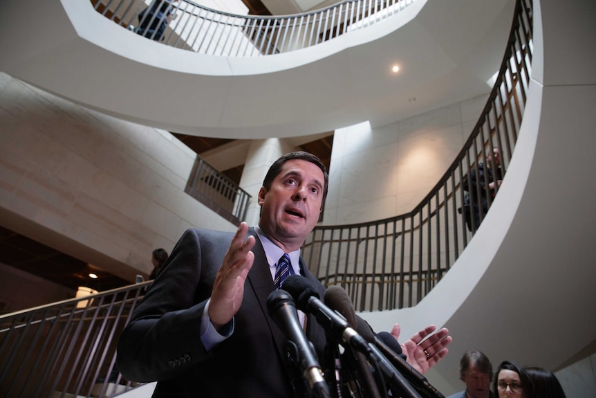 Devin Nunes speaks to reporters at the bottom of a stairwell.