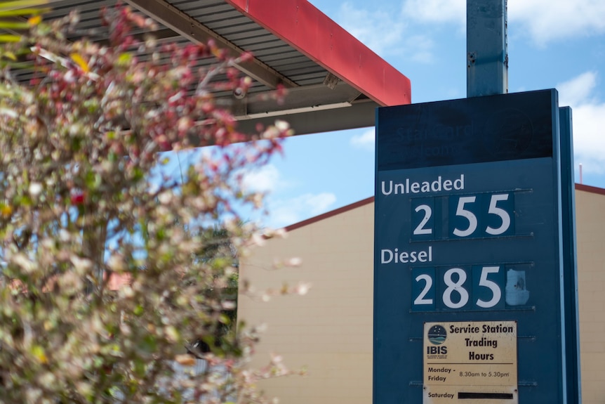 A fuel price sign lists unleaded at 255 cents per litre and diesel at 285 cents per litre.