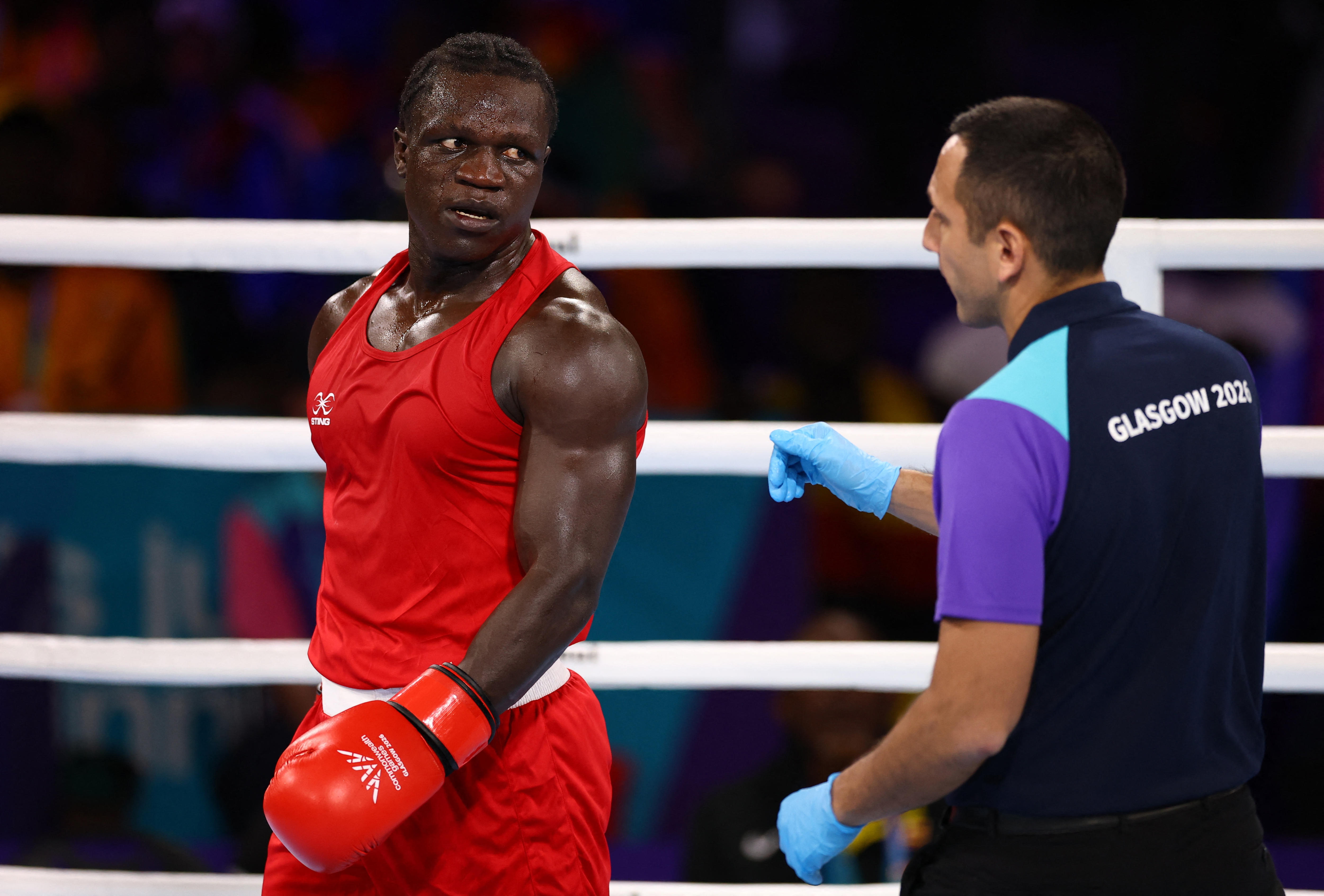 Aziz Abdul looks unhappily at the referee as he is disqualified during his Commonwealth Games fight.