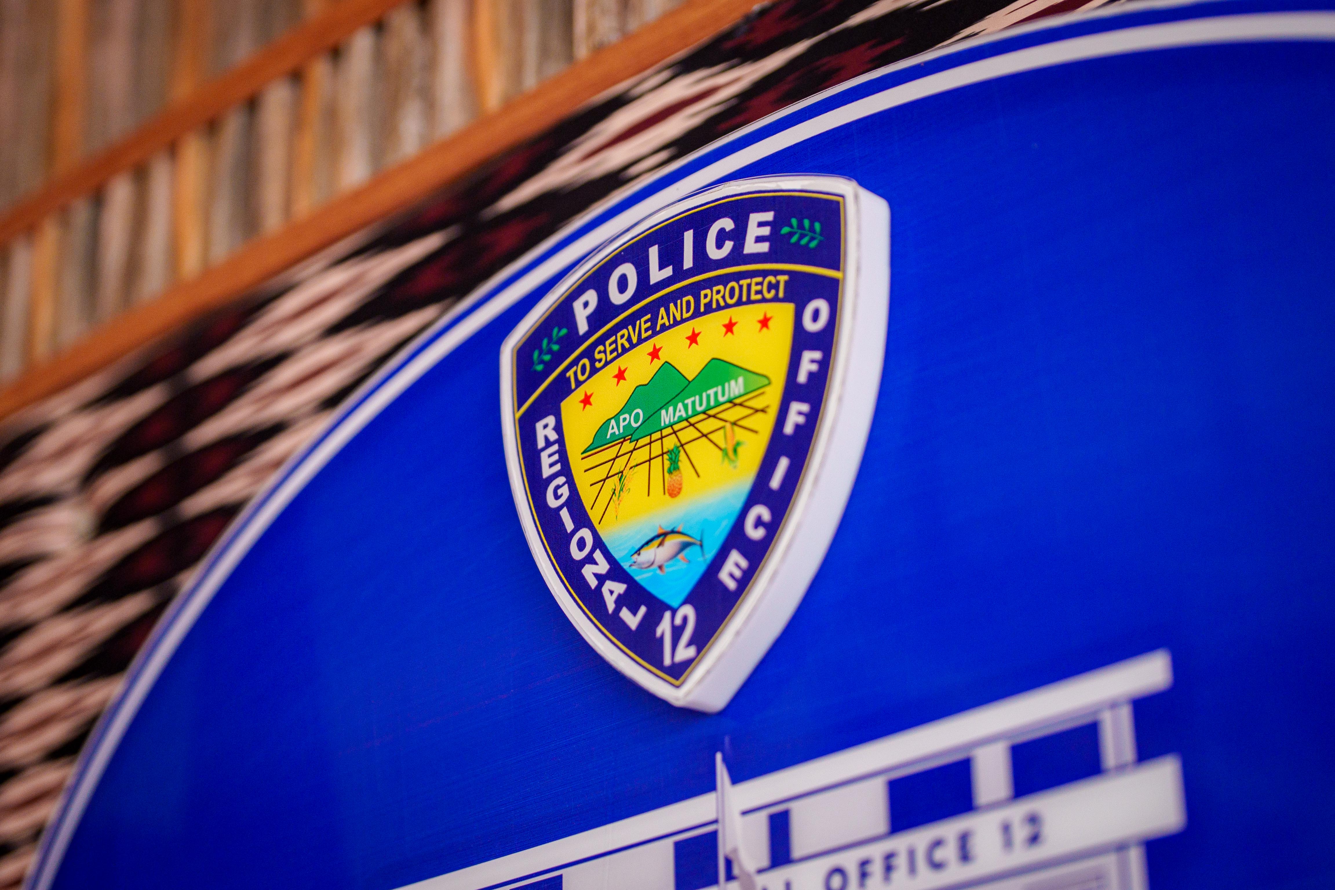 A police badge for a regional Philippines office that reads "to serve and protect".