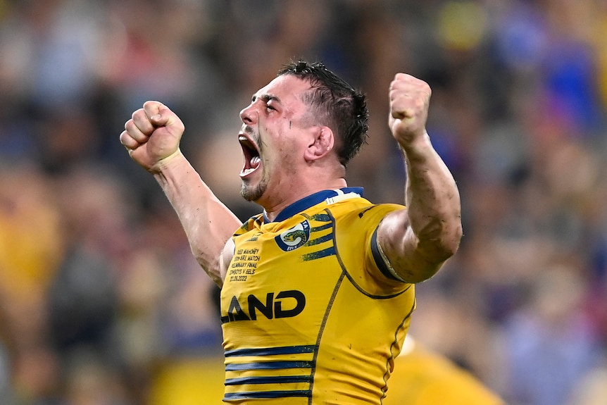 A man celebrates winning a rugby league match