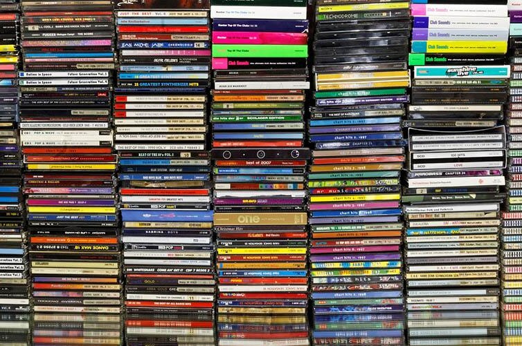 CDs are seen stacked on top of each other.