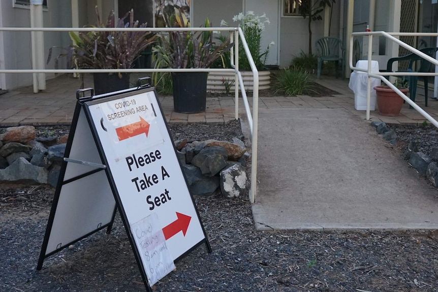 A COVID-19 screening sign sits outside the Norseman Hospital.