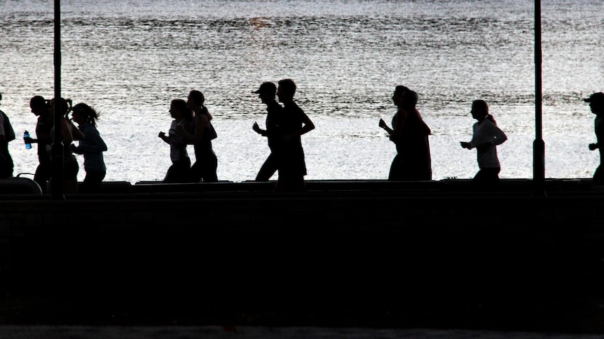 People jog during early morning exercise session.