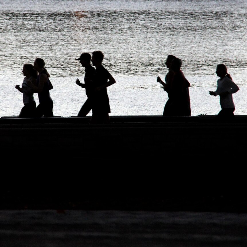 People jog during early morning exercise session.