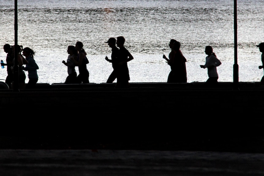 People jog during early morning exercise session.