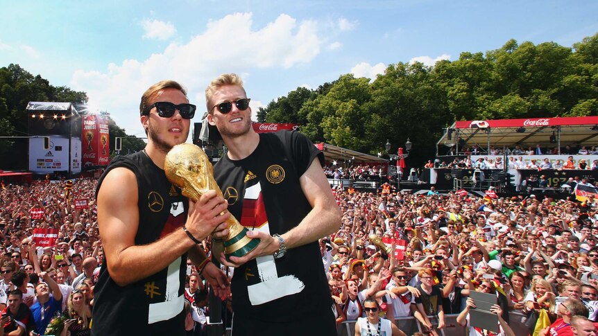Goetze and Schuerrle celebrate in Berlin with World Cup trophy