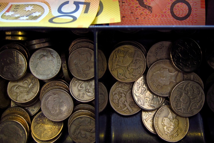 Coins and notes in a till. 