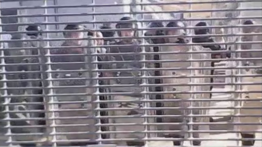 Security officers in riot gear at the Manus Island detention centre.