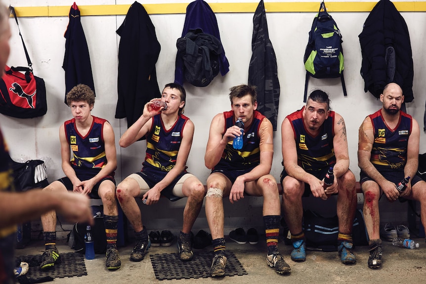 Crows players seated in rooms with bloodied knees for all