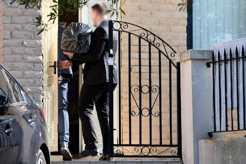 Police officers enter a home