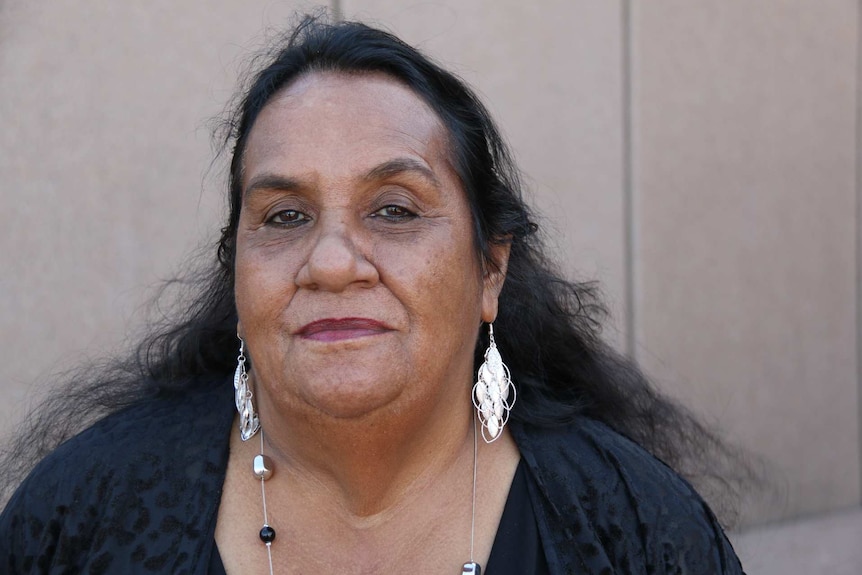 Cynthia Sariago, a Stolen Generations descendant whose mother was stolen, looks into the camera.