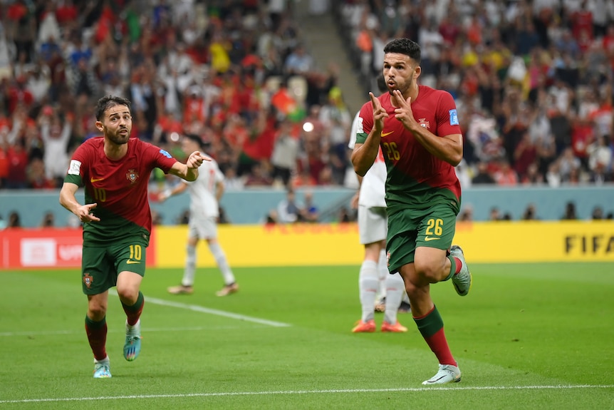 Goncalo Ramos does finger guns. Bernardo Silva chases after a goal for Portugal against Switzerland at the FIFA World Cup.