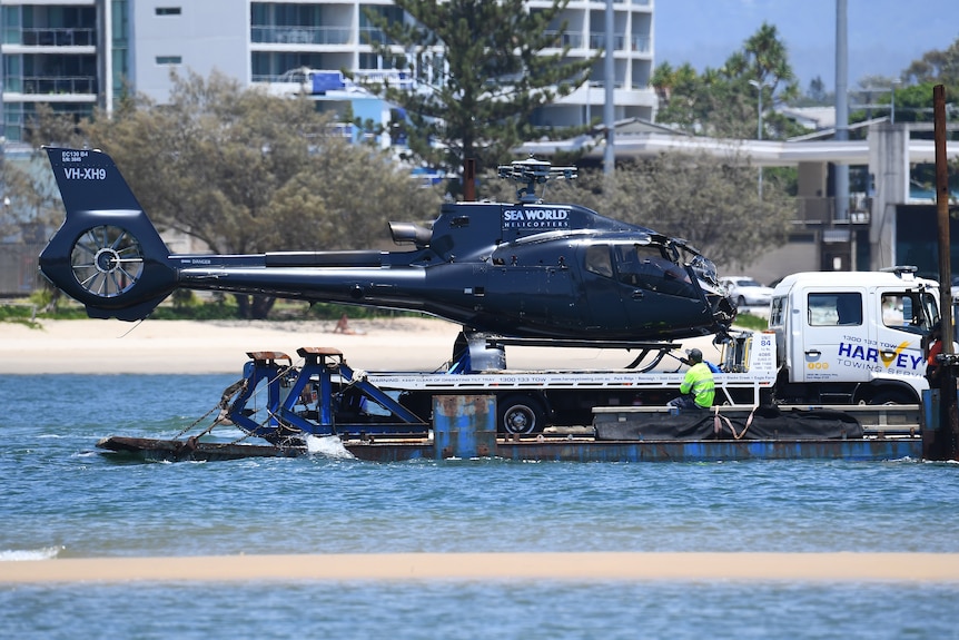 A helicopter on the back of a truck.