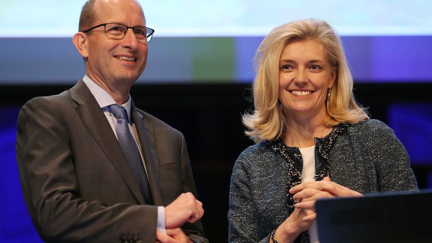 AMP's former CEO Craig Meller stands on stage with former chairman Catherine Brenner