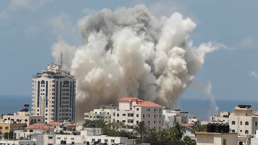 Smoke rises over a building in Gaza City