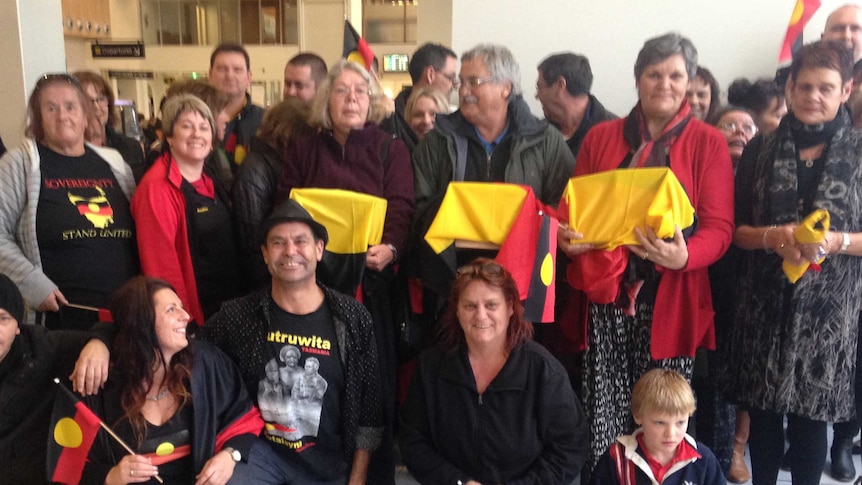 Supporters at Launceston airport welcome the return of Aboriginal remains repatriated from Chicago.