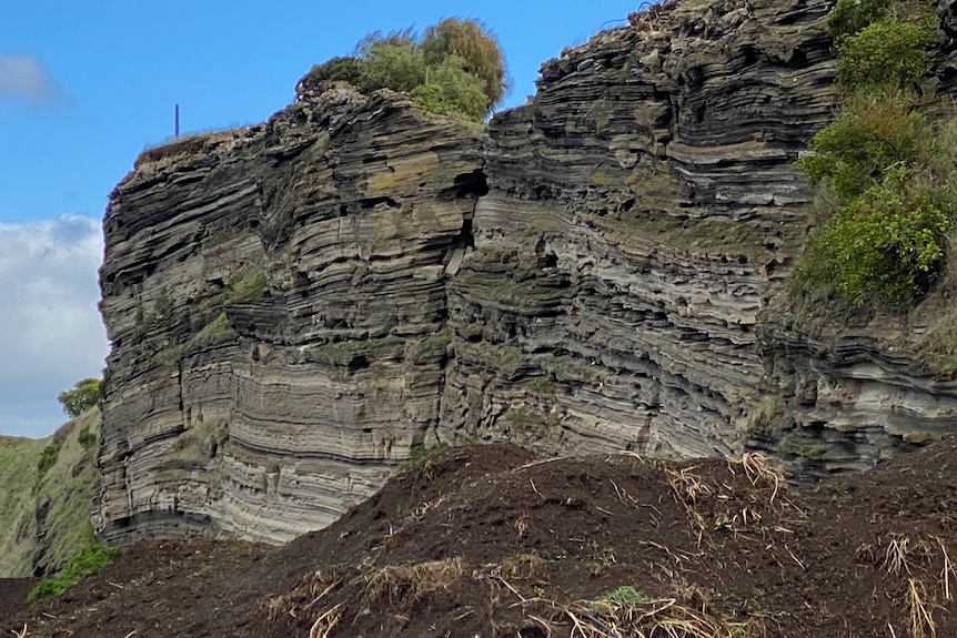Layered volcanic wall on edge of volcano