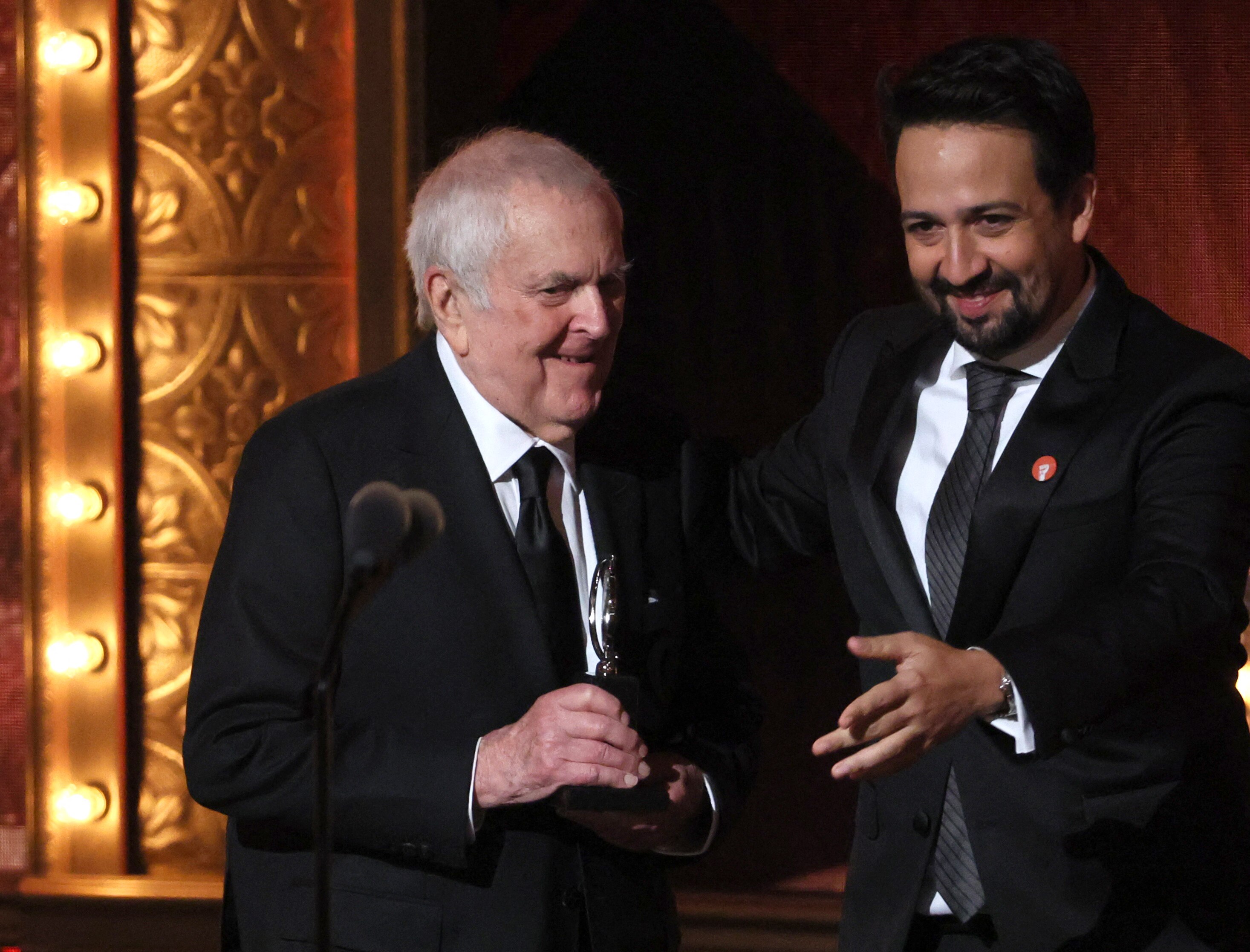 John Kander accepts an award onstage from Lin-Manuel Miranda at the 2023 Tony Awards.