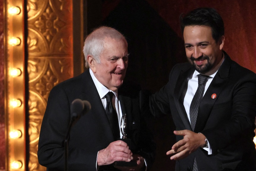 John Kander accepts an award onstage from Lin-Manuel Miranda at the 2023 Tony Awards.