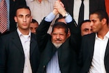 Mohamed Mursi (centre) is to be sworn in officially by the constitutional court.