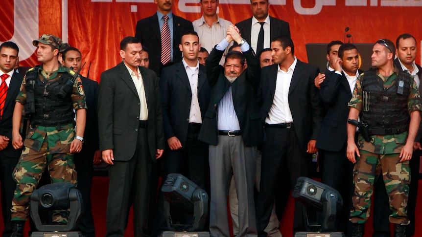 New powers: Mohamed Morsi (centre) with members of his presidential guard