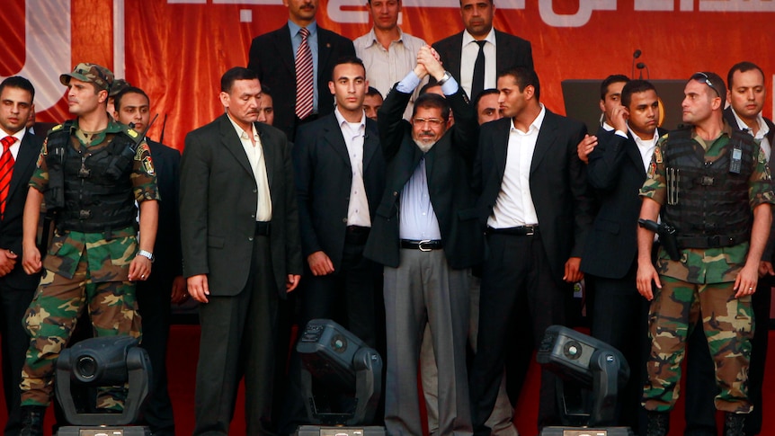 Mohamed Mursi (centre) is to be sworn in officially by the constitutional court.