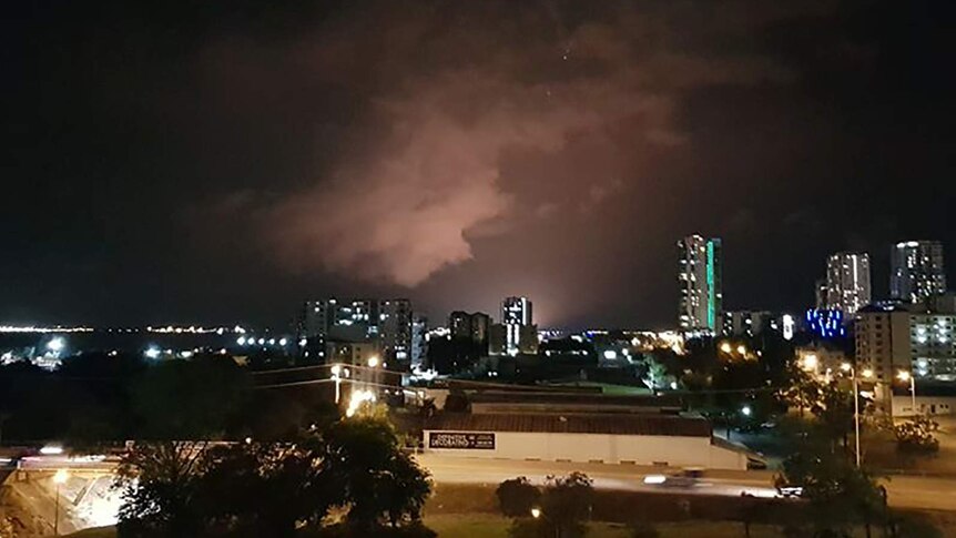A photo of Darwin city with a glow visible over the INPEX project.