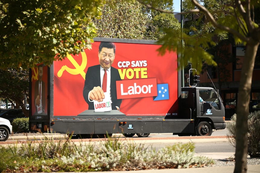 A truck featuring a red billboard of the Chinese president voting for Labor