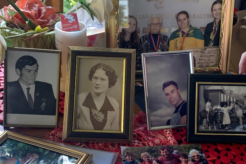 Assorted framed family photos on table