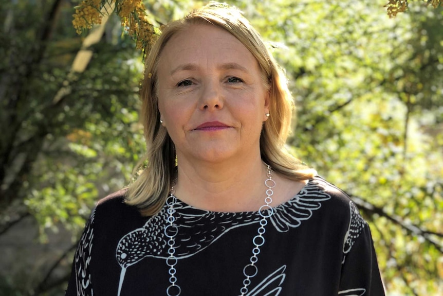 Fiona Owens stands under a wattle tree.