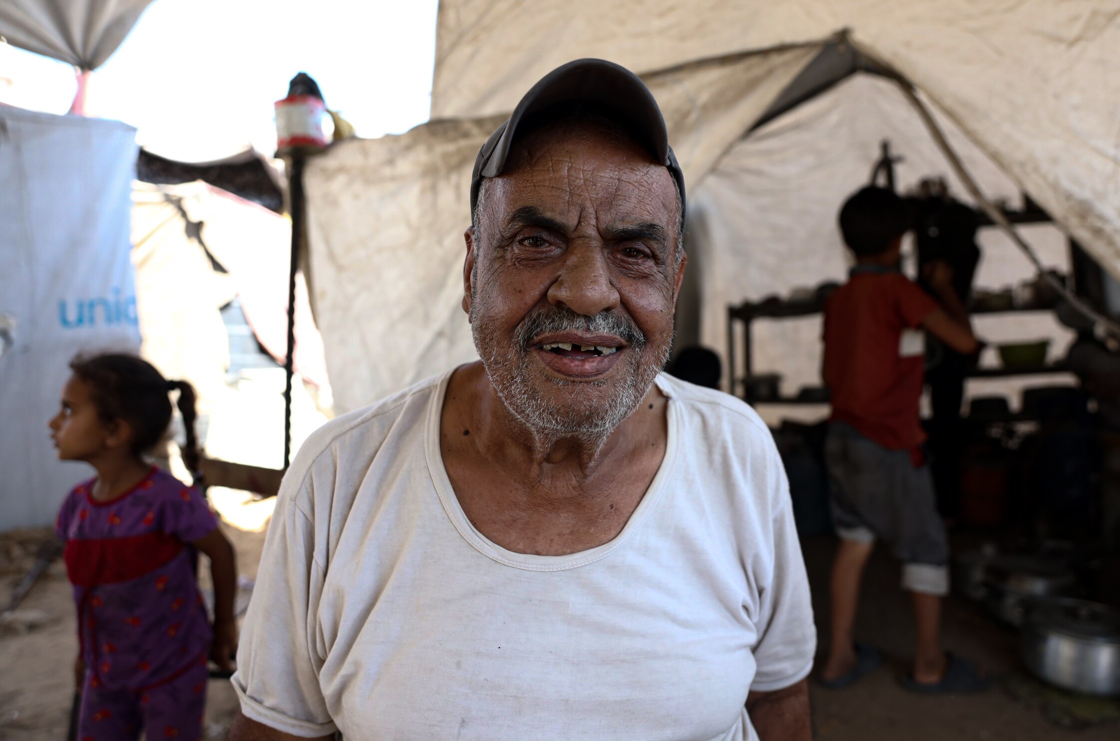 A photo of Fadel Naeem. He has brown eyes, he is wearing a black cap, and he is smiling.