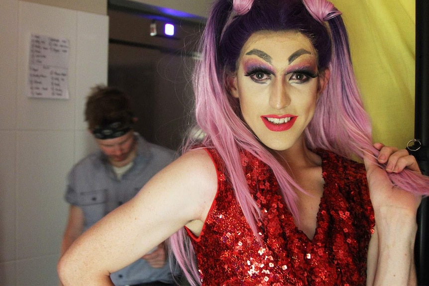 drag queen with ponytails backstage at a nightclub