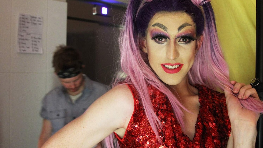 drag queen with ponytails backstage at a nightclub