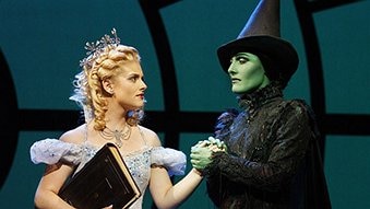 Lucy Durack and Jemma Rix in costume, one as a fairy godmother and one as an evil witch.